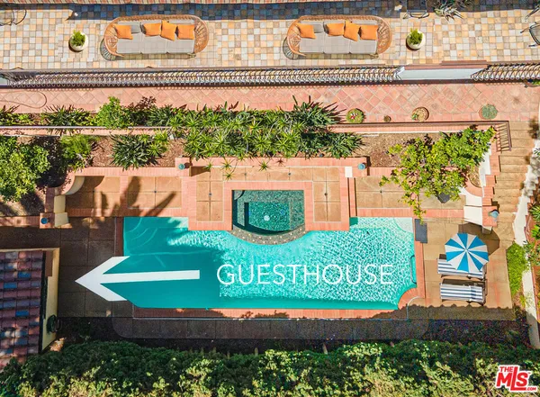 a kitchen with a refrigerator and white cabinets