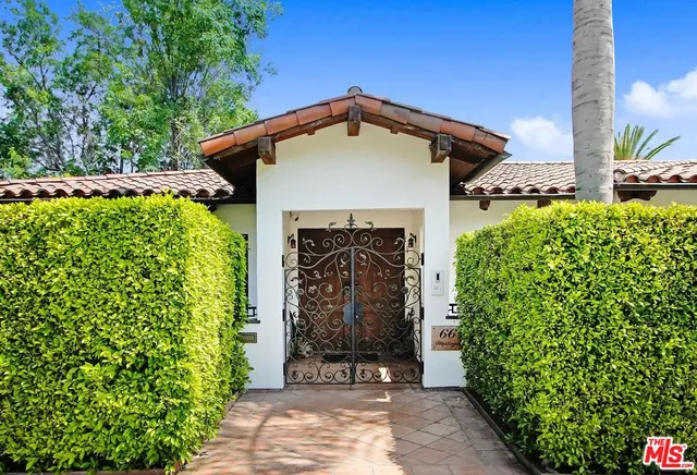 a living room with furniture kitchen view and a large window