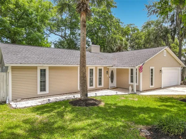 a front view of house with yard and green space