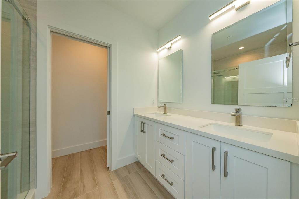 a bathroom with a double vanity sink and mirror