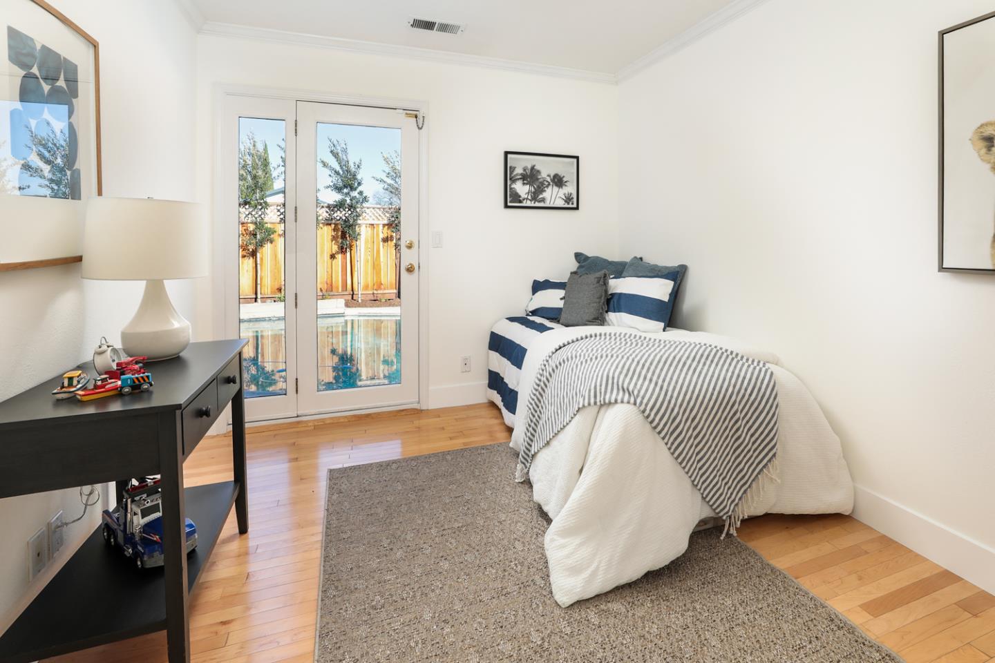735 Ashbourne Drive Sunnyvale, CA 94087 - Photo 11 of 25 a bedroom with a bed and wooden floor