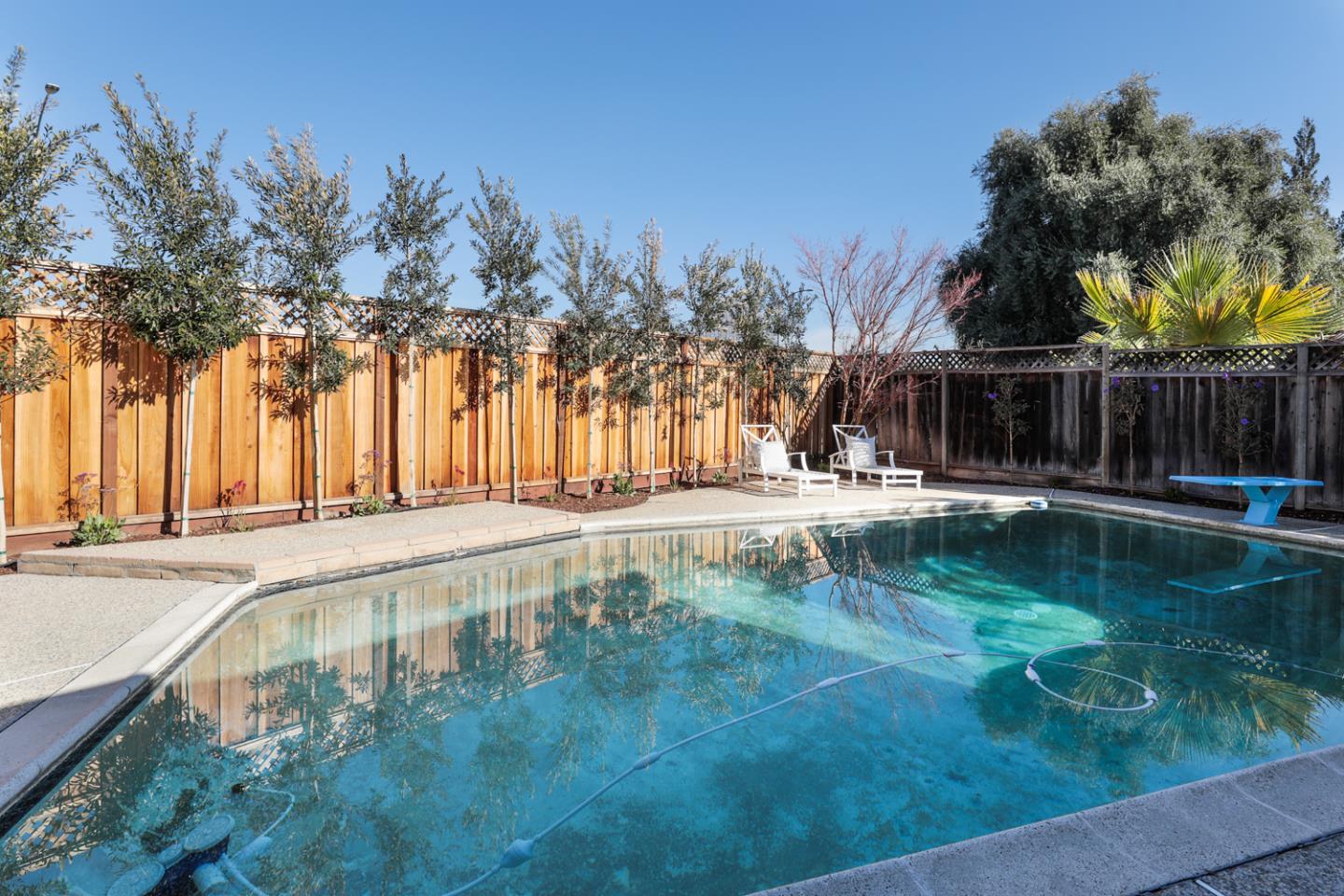 735 Ashbourne Drive Sunnyvale, CA 94087 - Photo 23 of 25 a swimming pool with outdoor seating and yard
