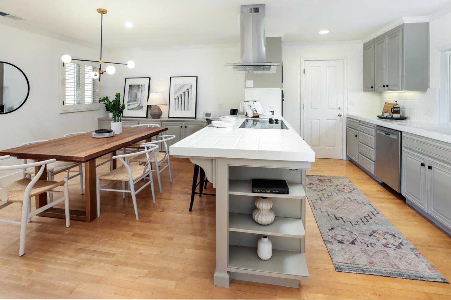 735 Ashbourne Drive Sunnyvale, CA 94087 - Photo 8 of 25 a kitchen with stainless steel appliances kitchen island granite countertop a table chairs in it and wooden floors