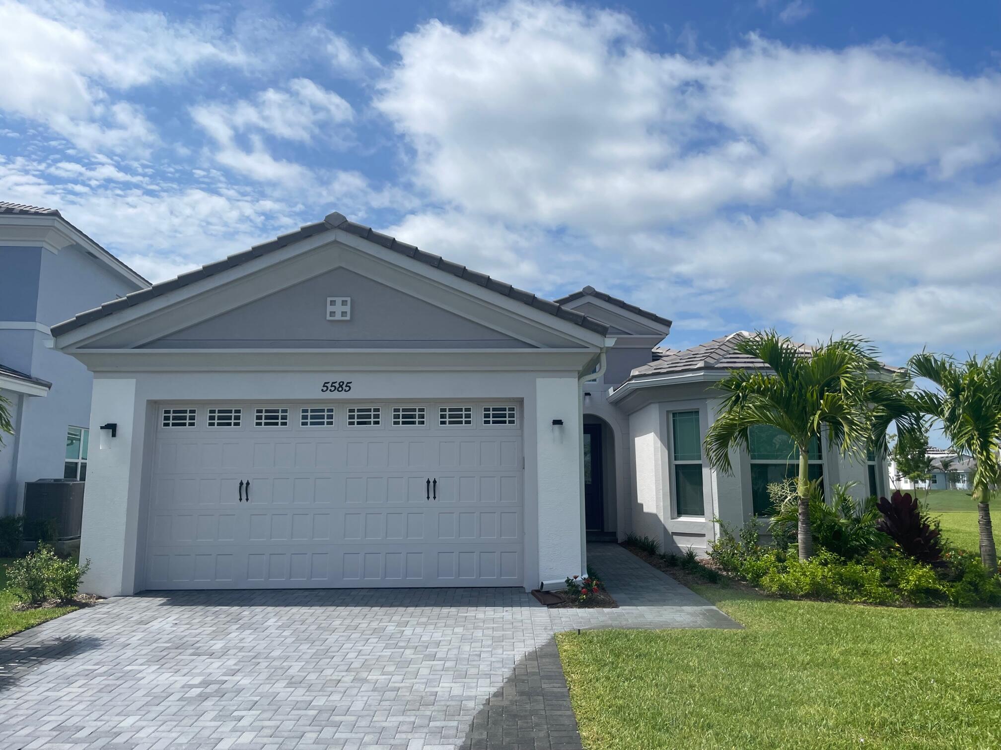 5585 Macoon Way, Unit 5585 Loxahatchee, FL 33470 - Photo 1 of 14 a front view of a house with a yard