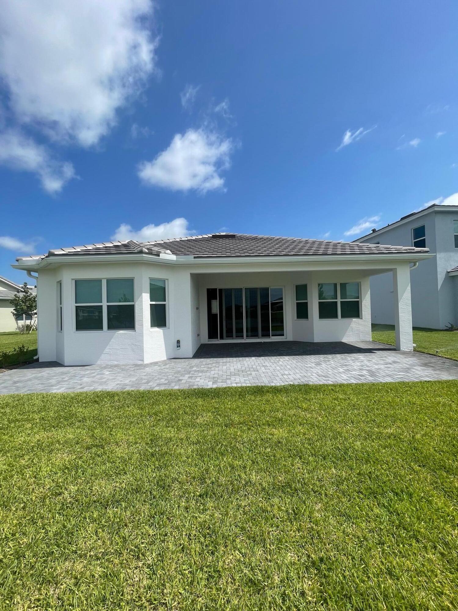 5585 Macoon Way, Unit 5585 Loxahatchee, FL 33470 - Photo 12 of 14 a view of a house with a patio