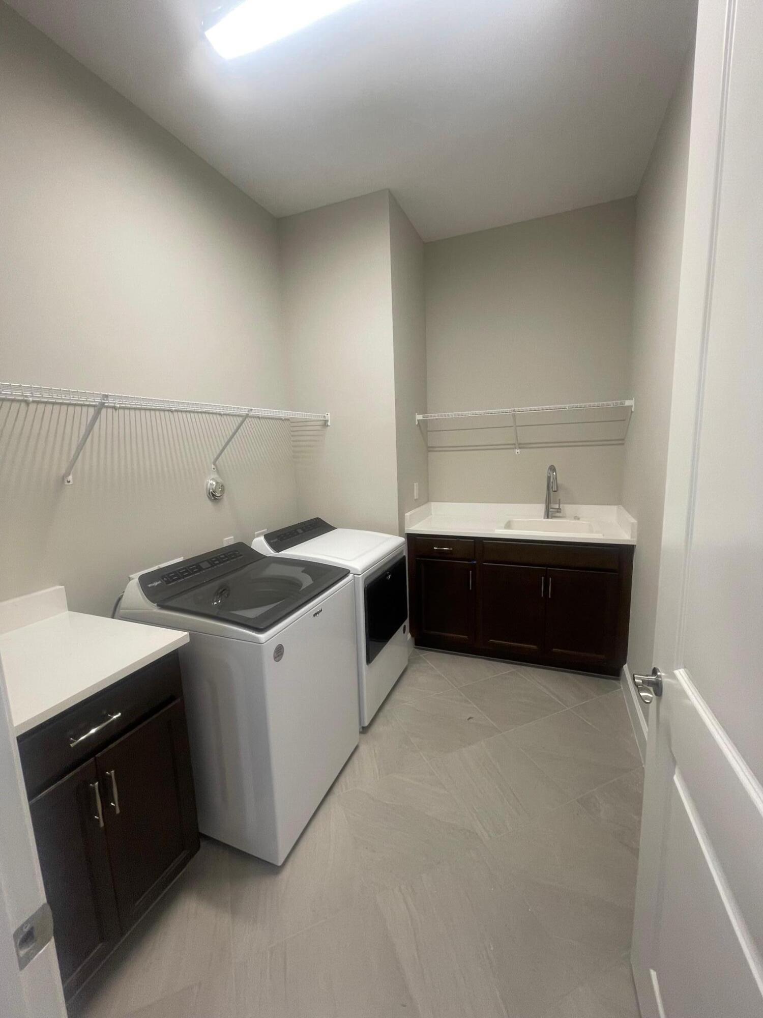 5585 Macoon Way, Unit 5585 Loxahatchee, FL 33470 - Photo 13 of 14 a utility room with a sink a washer and dryer