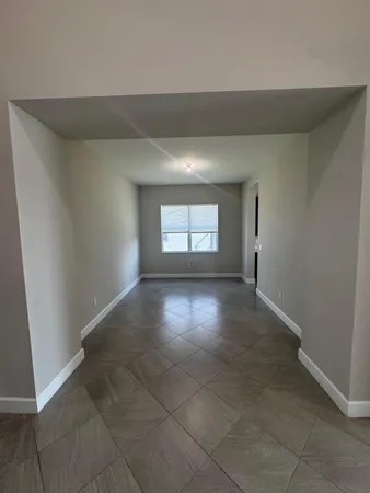 a view of kitchen with stainless steel appliances granite countertop a stove and a sink