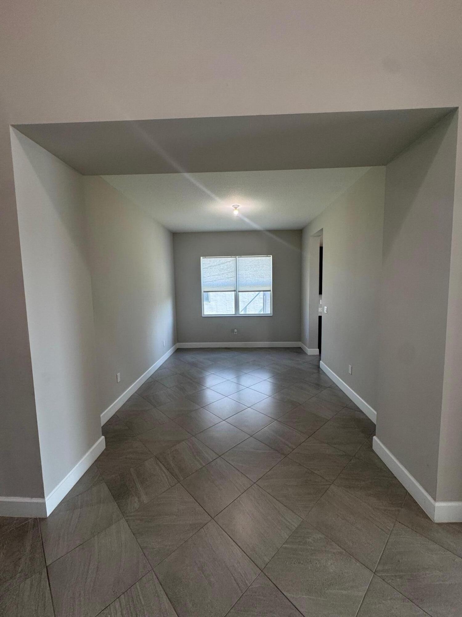 5585 Macoon Way, Unit 5585 Loxahatchee, FL 33470 - Photo 5 of 14 an empty room with a window