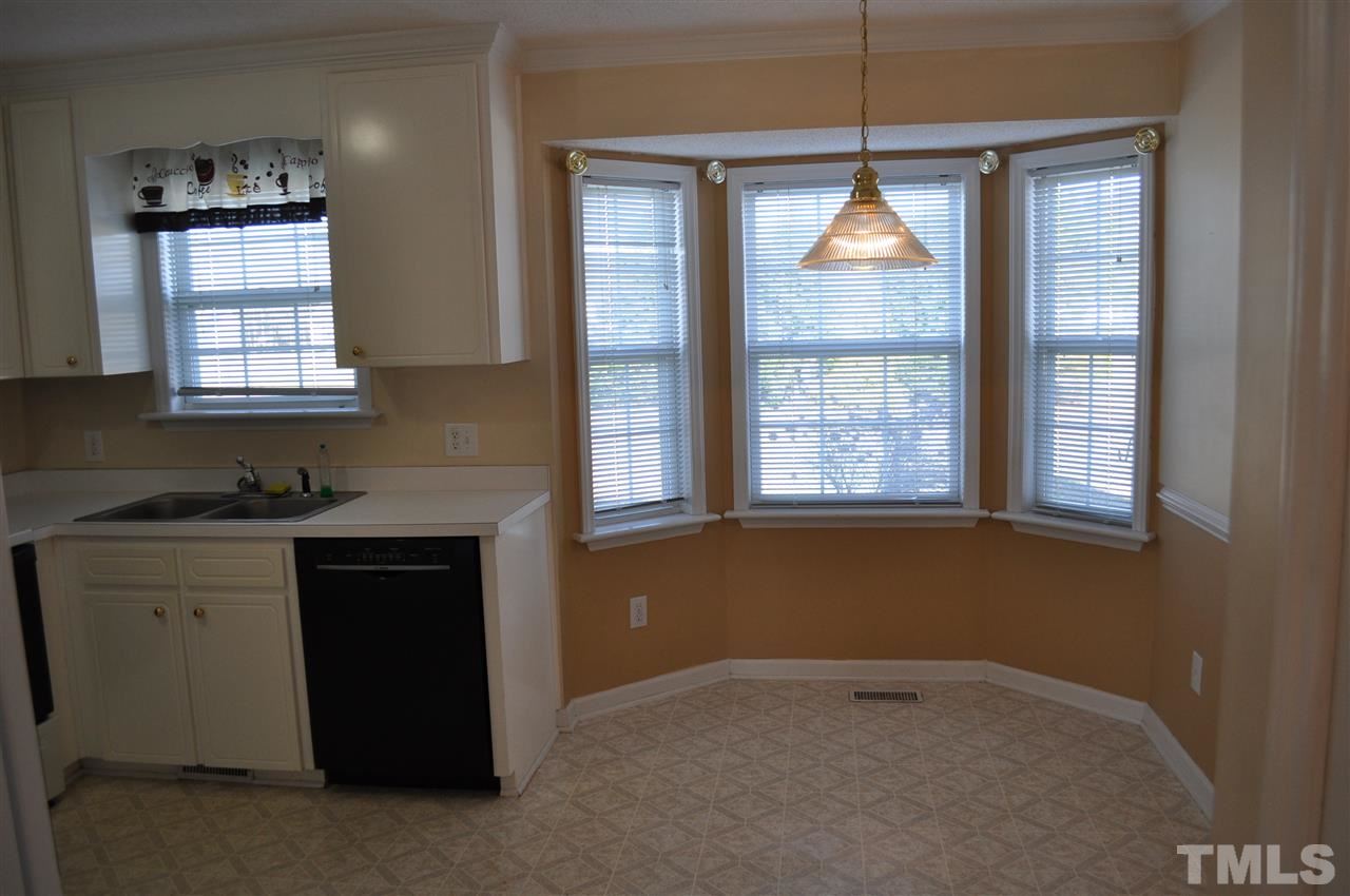 1113 Holland Ridge Drive Raleigh, NC 27603 - Photo 11 of 24 a kitchen with windows and cabinets