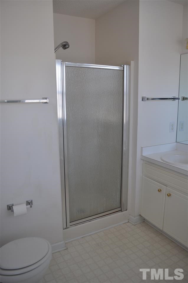 1113 Holland Ridge Drive Raleigh, NC 27603 - Photo 14 of 24 a bathroom with a sink a toilet and shower