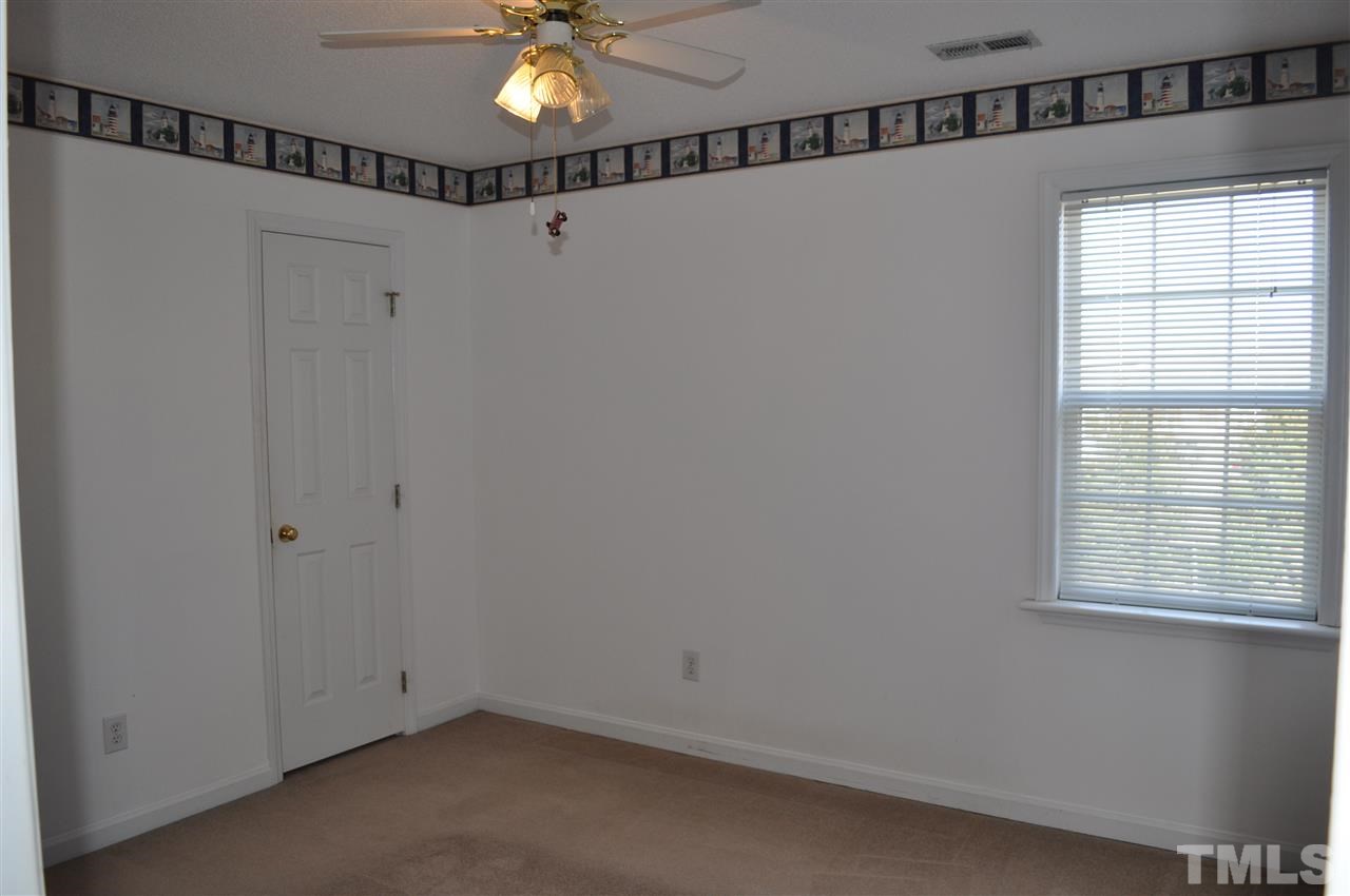 1113 Holland Ridge Drive Raleigh, NC 27603 - Photo 15 of 24 a view of a room with a window and a fan