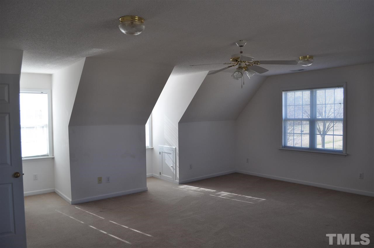 1113 Holland Ridge Drive Raleigh, NC 27603 - Photo 18 of 24 an empty room with windows and fan