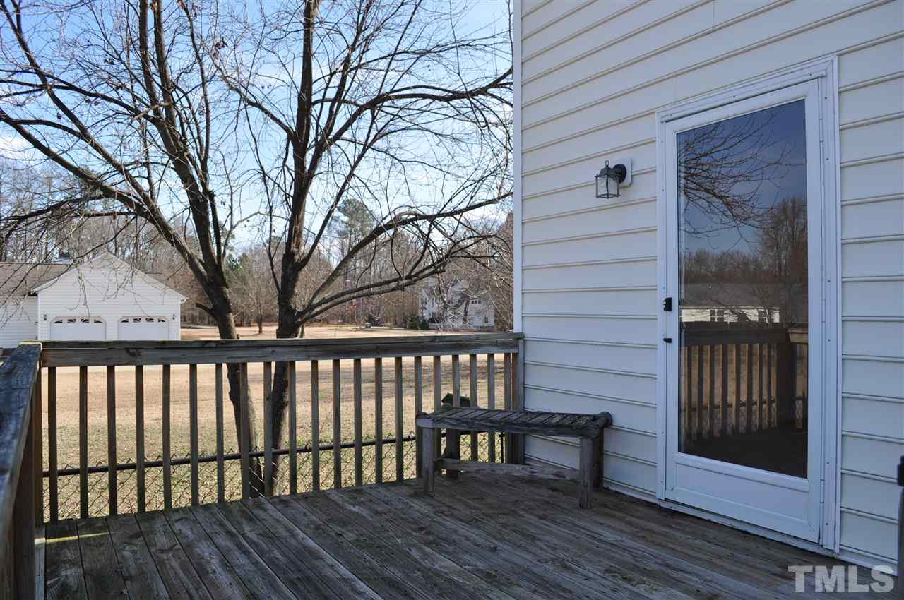 1113 Holland Ridge Drive Raleigh, NC 27603 - Photo 22 of 24 a view of a wooden bench next to a yard
