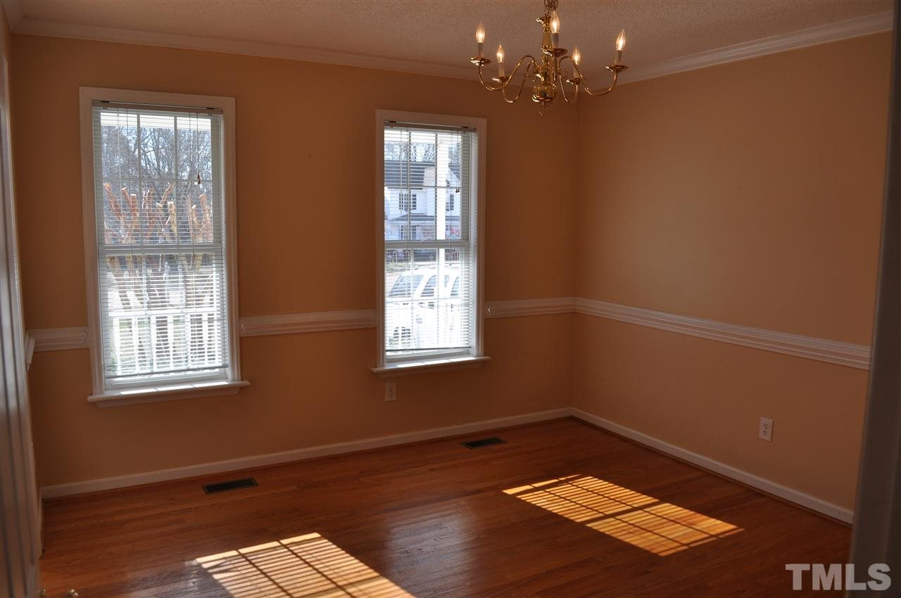 1113 Holland Ridge Drive Raleigh, NC 27603 - Photo 7 of 24 a view of an empty room with a window and wooden floor