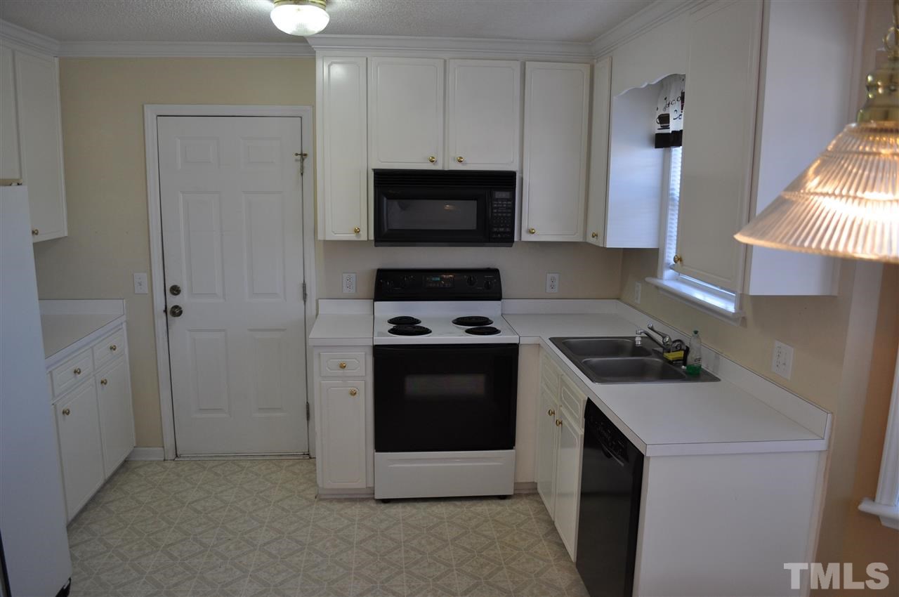 1113 Holland Ridge Drive Raleigh, NC 27603 - Photo 9 of 24 a kitchen with a stove and a microwave