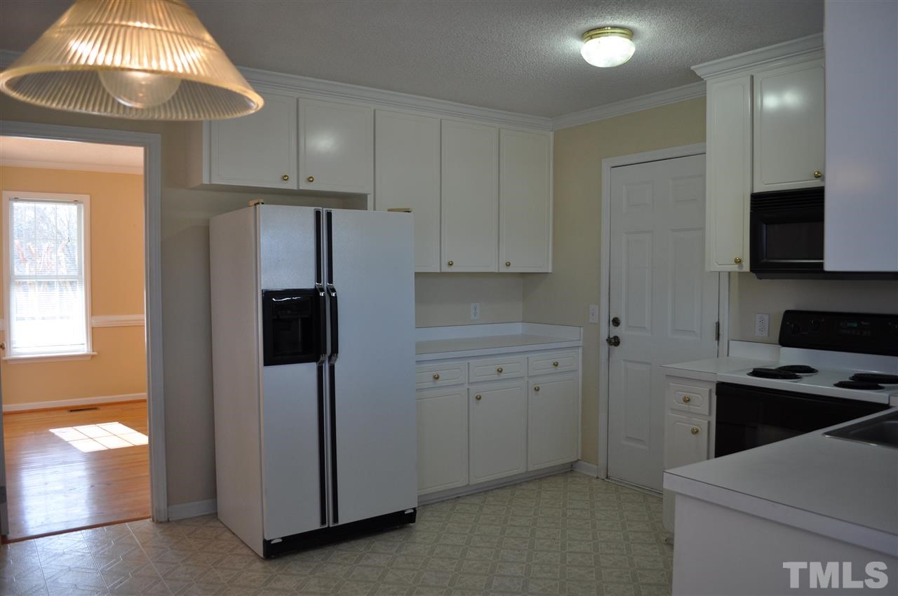 1113 Holland Ridge Drive Raleigh, NC 27603 - Photo 10 of 24 a kitchen with a refrigerator and a stove