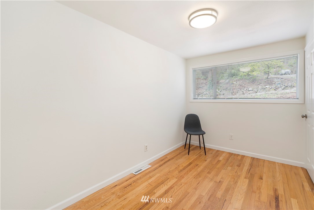 15612 Renton Issaquah Road Southeast Renton, WA 98059 - Photo 12 of 30 a room with a window and a chair
