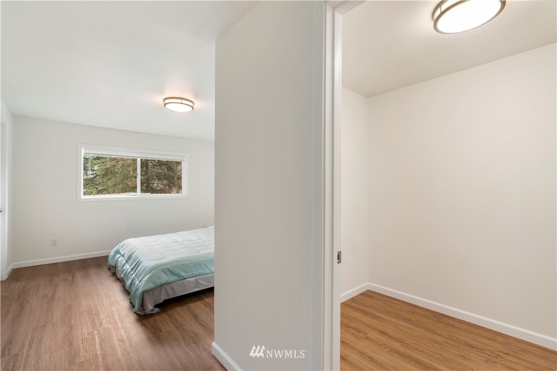 15612 Renton Issaquah Road Southeast Renton, WA 98059 - Photo 17 of 30 a room with a bed and a wooden floor
