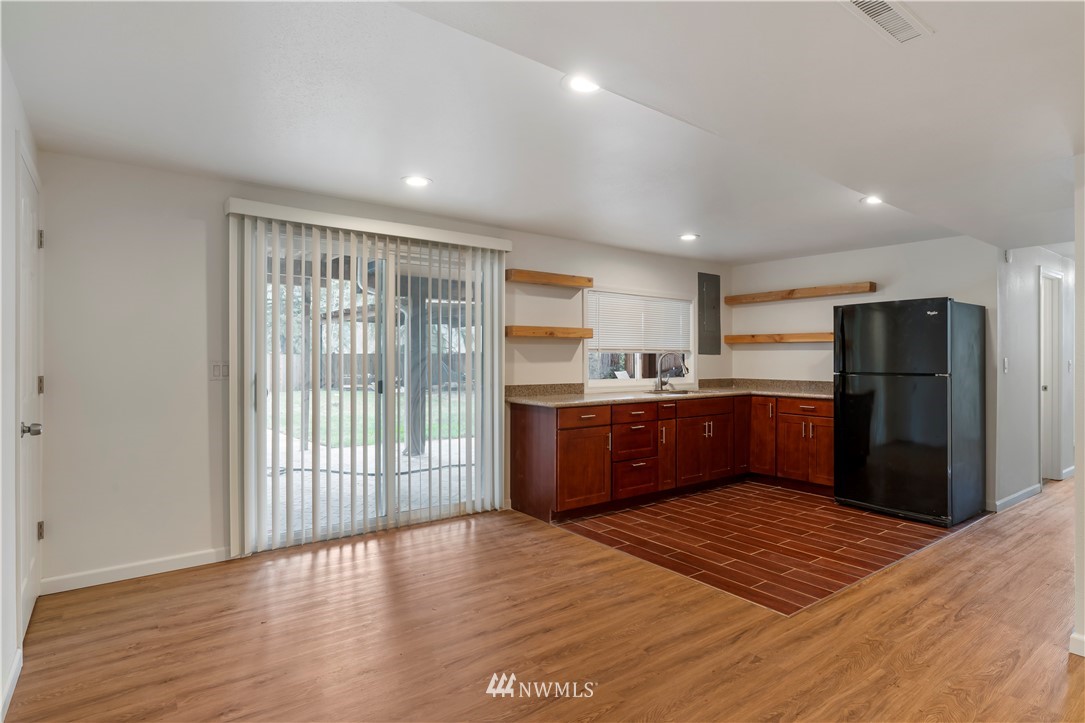 15612 Renton Issaquah Road Southeast Renton, WA 98059 - Photo 22 of 30 a kitchen with stainless steel appliances granite countertop a refrigerator and a wooden floors