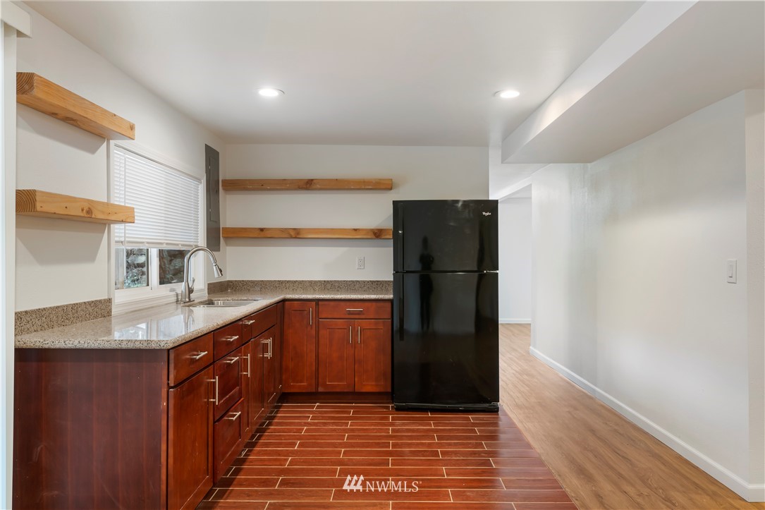 15612 Renton Issaquah Road Southeast Renton, WA 98059 - Photo 23 of 30 a kitchen with stainless steel appliances granite countertop a refrigerator and a sink