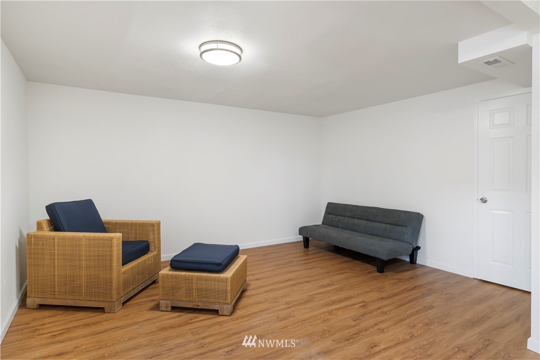15612 Renton Issaquah Road Southeast Renton, WA 98059 - Photo 26 of 30 a room with furniture and wooden floor