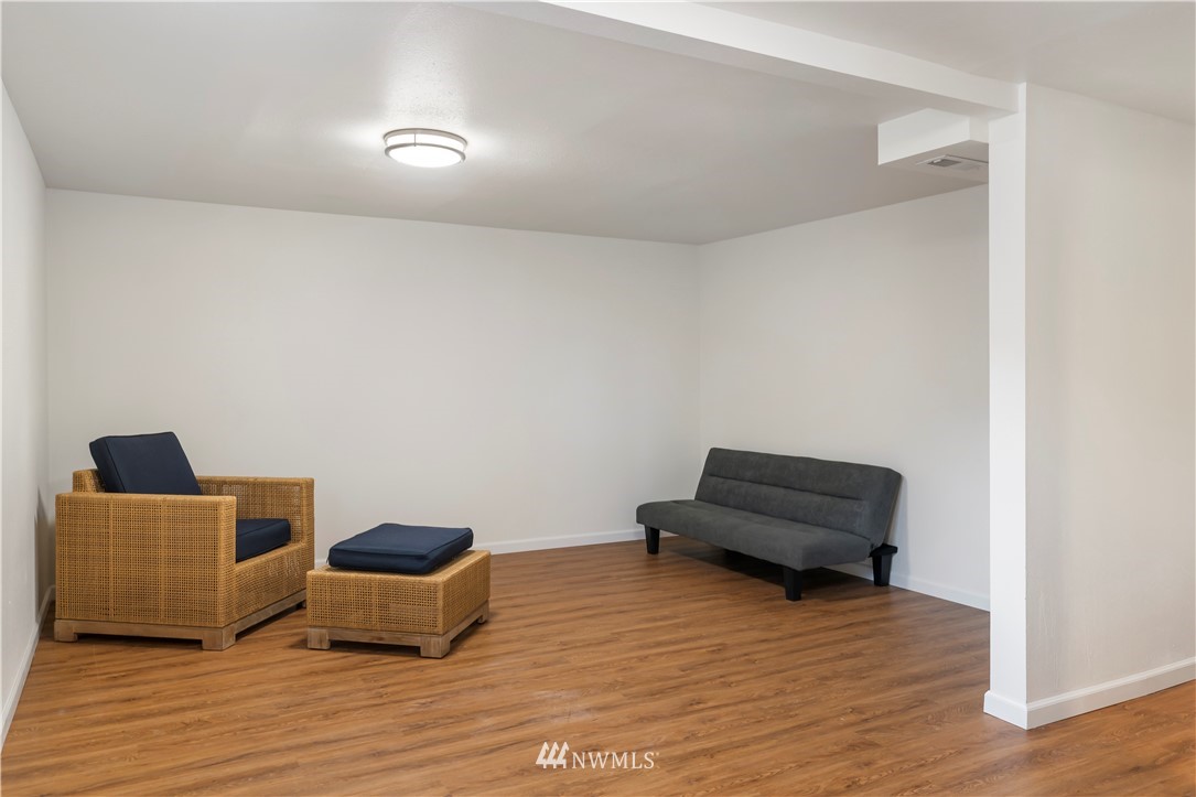 15612 Renton Issaquah Road Southeast Renton, WA 98059 - Photo 27 of 30 a room with furniture and a wooden floor