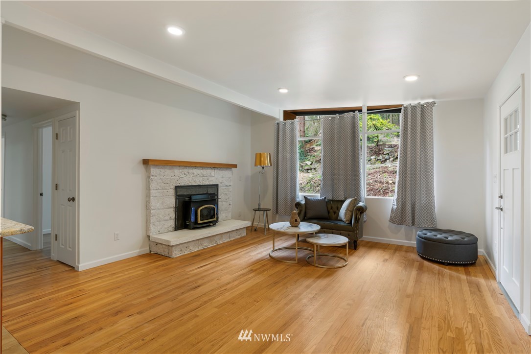 15612 Renton Issaquah Road Southeast Renton, WA 98059 - Photo 3 of 30 a living room with furniture and a fireplace