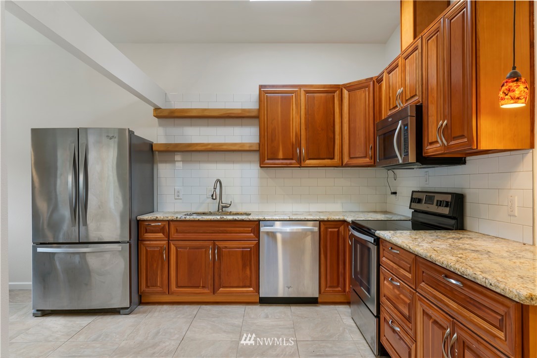 15612 Renton Issaquah Road Southeast Renton, WA 98059 - Photo 8 of 30 a kitchen with stainless steel appliances granite countertop a refrigerator a sink a stove and dishwasher