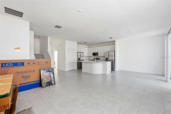 a view of kitchen with furniture and refrigerator