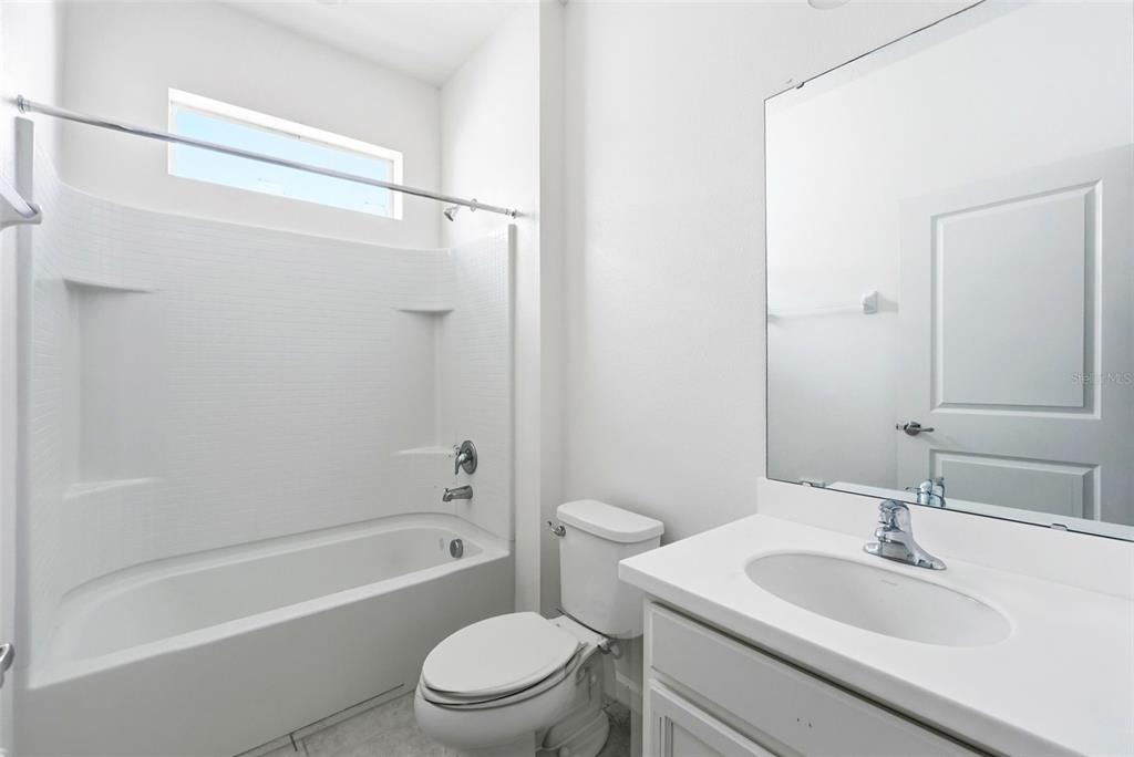 4483 Monado Drive Kissimmee, FL 34746 - Photo 23 of 43 a bathroom with a sink toilet and shower