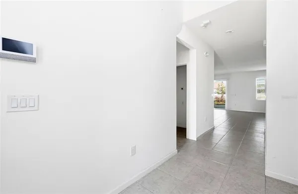 a view of a hallway with wooden shelves