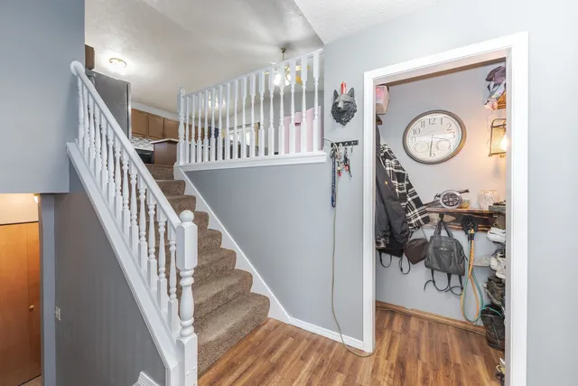 a view of a hallway with wooden floor and entryway