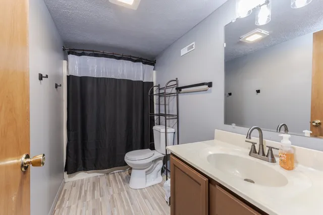 a bathroom with a sink toilet and shower
