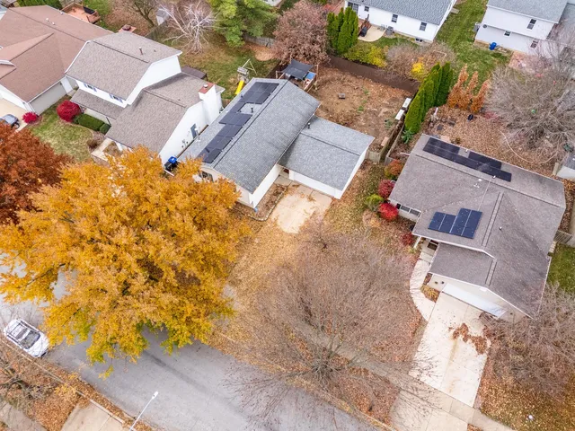 an aerial view of residential house with parking