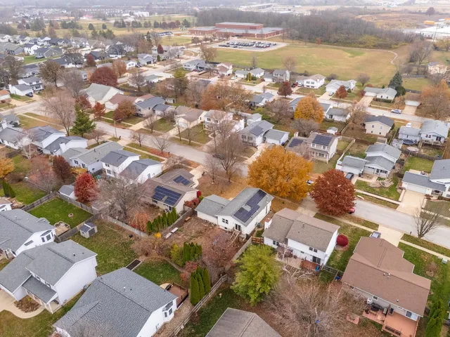 an aerial view of residential building with parking