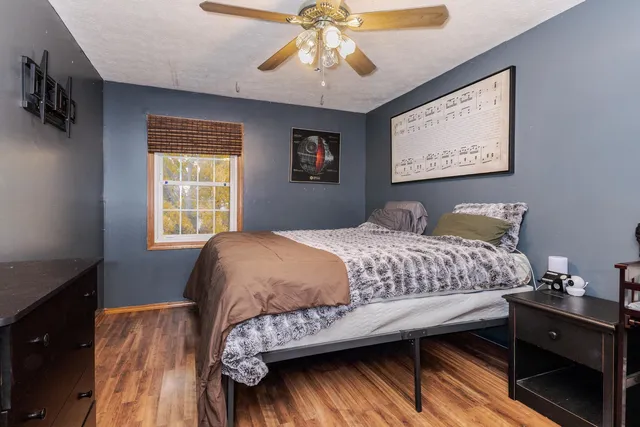 a bedroom with a bed and a window