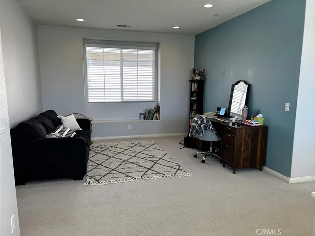 a bedroom with bed and a window