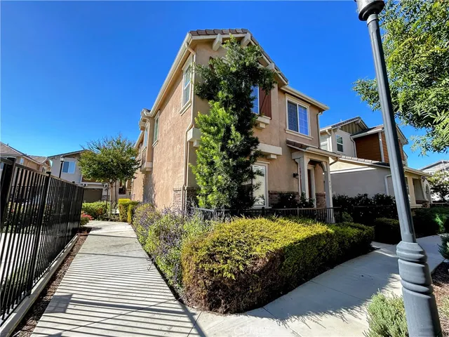 a view of a house with backyard and sitting area