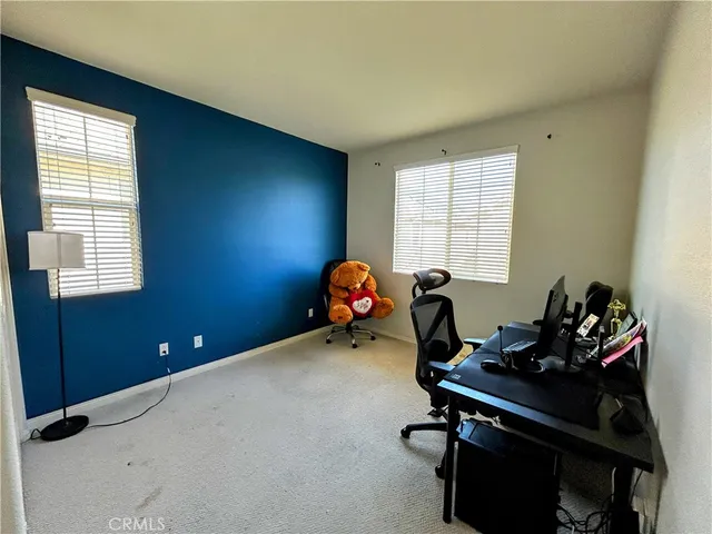 a view of a house with potted plants