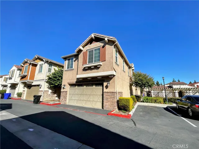 a view of building with cars parked