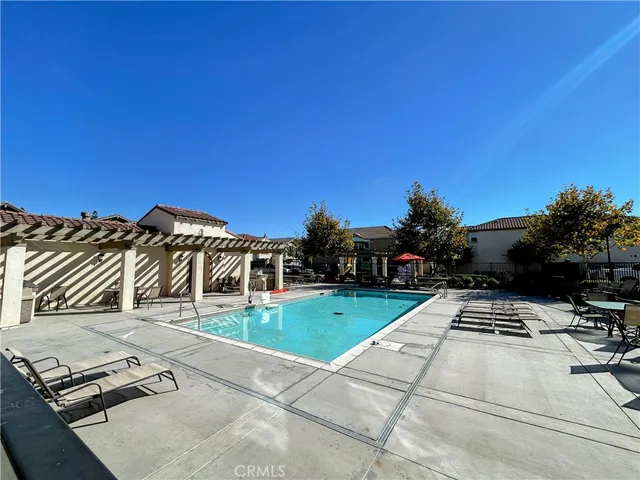 a view of a tennis ground with large trees