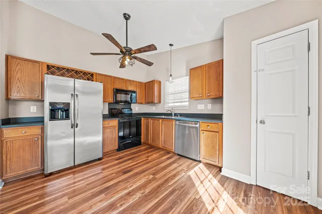 a kitchen with stainless steel appliances granite countertop a refrigerator and a sink
