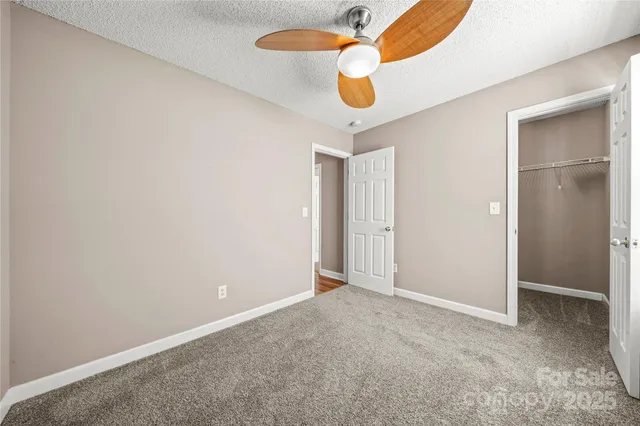 an empty room with closet and wooden floor
