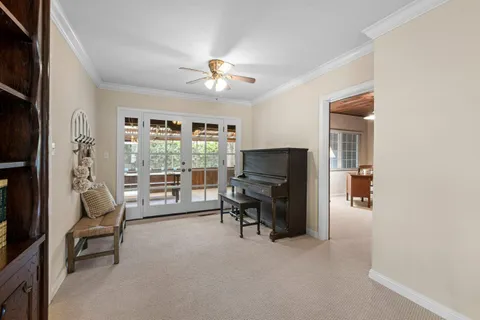 a view of a dining room with furniture a chandelier and wooden floor