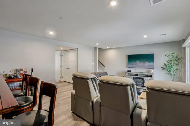 a view of a dining room with furniture and a flat screen tv
