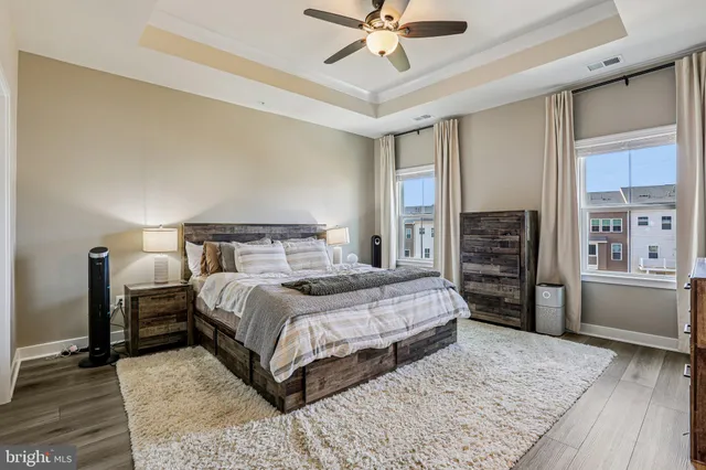 a bedroom with a large bed and a chandelier