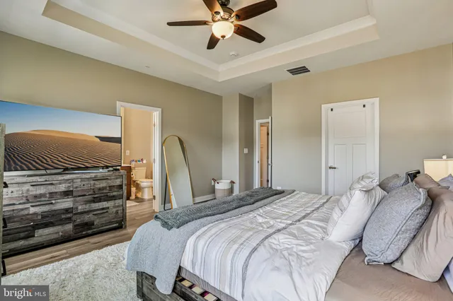 a bedroom with a bed and ceiling fan