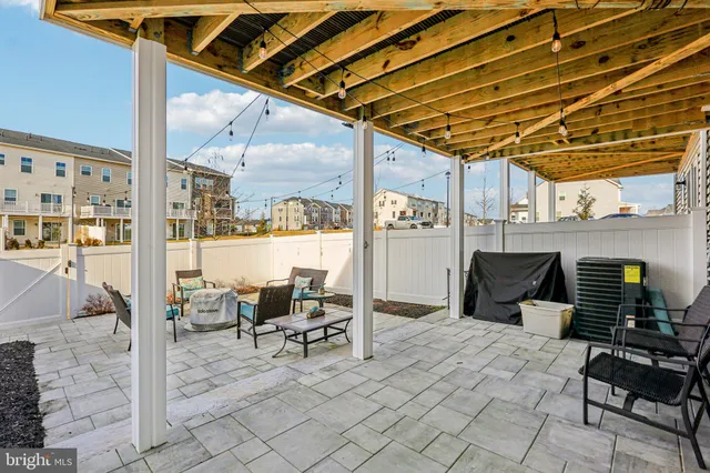 a view of a patio with table and chairs and potted plants