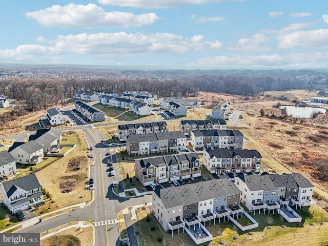 an aerial view of a city with ocean view in back