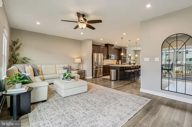 a living room with furniture and kitchen view